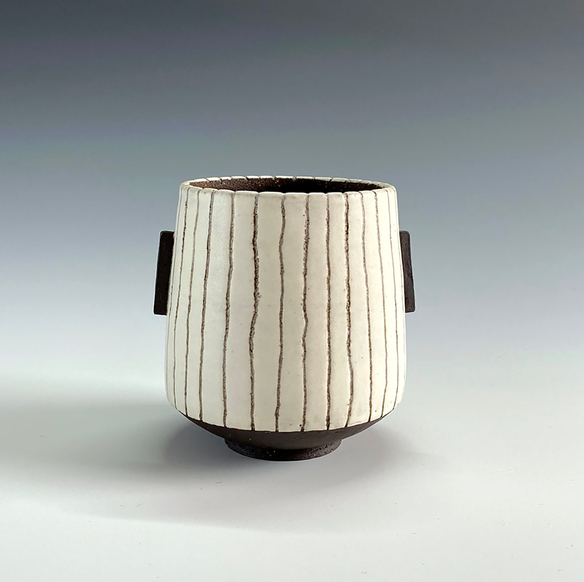 Black and white vessel with stripes