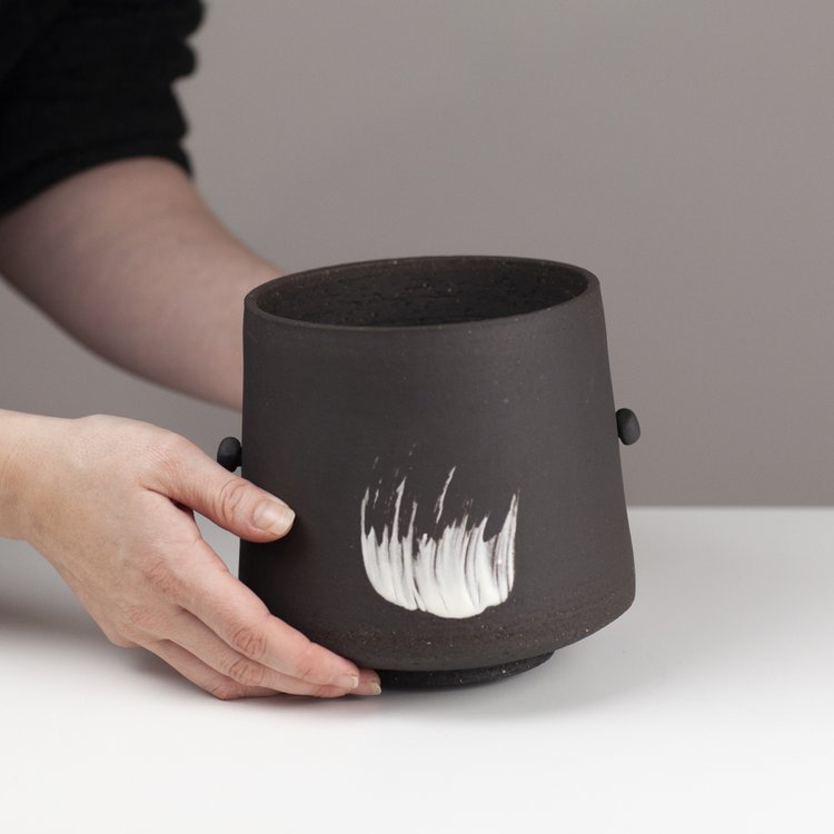 Black industrial vessel with movable “handles”